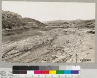 Tehachapi Flood of September 1932. View down Cache Creek above Monolith showing widely cut flood channel. F. Renner with rod. Metcalf on cut bank