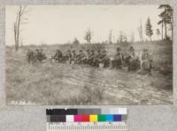 Crew resting at the fire line at end of 40, Fyfe Lake Forest. They carry both red and jack pines and plant them alternately 6 x 6. Mich