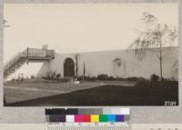 Court of Mr. Meinck's house near Palmdale with weeping willow, Italian cypress, various shrubs and a clover lawn. Shows effectiveness of windbreak by walls in desert conditions. Metcalf. February, 1926