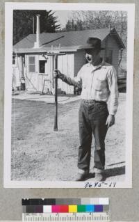 John Hamilton, Christmas tree planter of Monterey County, with planting dibble he made from a piece of pipe. He got 90% survival planting with this tool on N. slope. Metcalf. Feb. 1953