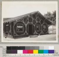 "Log" house. Johnson's Novelty Store, Garberville, California. Built June-July 1936. Redwood log sections, 12" thick, set one edge and in cement--sapwood and bark included. The large log sections were split and center square removed for openings. 7-31-37 E. F