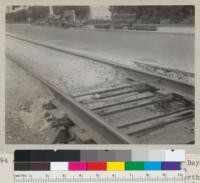 A type of steel cross tie used by East Bay Railway system on Bancroft Way opposite Stadium, between Dana and Telegraph (north track). Steel angle irons with creosoted wood block spacer. The trapezoidal wood block is only for support during pouring of the concrete. See also 5893. Sept. 1935. E. F