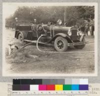 The Mack rural fire truck with Byron Jackson pump during demonstration at Davis, October 1930. The new pump will throw up to 400 gallons per minute of water and maintain a very high pressure. Cost of outfit $6000. Fairbank