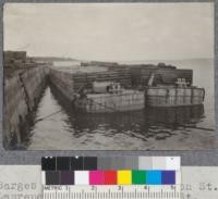 Barges loading with lumber on St. Lawrence river at plant of St. Maurice Lumber Company, Three Rivers, Quebec