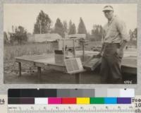 Clipper seed grader in use at Eddy Tree Breeding Station. Costs $30.00 with 10 graded screens. Extra screens 75 cents each. Runs by hand and does a very satisfactory job. Seeds shown are white fir. August 1927. Metcalf