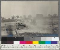 At the tractor demonstration at Davis, May, 1918. Machines going from the exhibition grounds to the field for demonstration of plowing. Best tractor, 75-horse power, with new style spark arrester, in the foreground