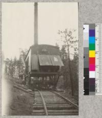 Electric skidder (Willamette) showing empty car passing beneath. Sugar Pine Company