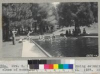 Mrs. W. E. Newlon instructs a beginning swimming class of women at Whitaker's Forest pool. Metcalf. 1937