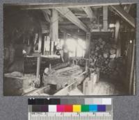 Interior of saw mill cutting White Pine on St. Croix River at Baring, Maine. Logs very small. Sometimes sawed one on top of the other as in this picture. Carriage very light. D.T. Mason 1919