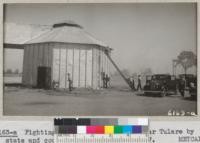 Fighting a fire in cotton gin near Tulare by state and county fire equipment. 1937