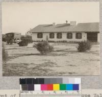 Front of Meinck house in Antelope Valley near Palmdale, showing native creosote bush, deciduous tamarisk and yucca used for landscaping in the desert. Metcalf. February, 1926