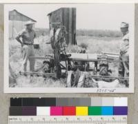 A Holland celery planter modified to plant tree. Women operate and machine propels self at 10 ft/min. Plants 12,500 trees per day per wheel. Two wheels/machine. Oakdale Nursery