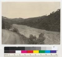 Glacier-like flow and deposit of debris from La Grange hydraulic mine near Weaverville. Post and brush fence being built by Highway Commission to keep flow to the south (right). See also #5933. 4-25-36, E.F