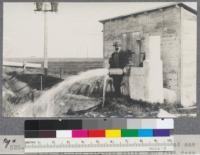 Mr. W. M. Shaw of Willows, Glenn County and one of his flowing artesian wells, 800 feet deep. Mr. Shaw built the first lookout station in the United States in the Kennebeck Valley, Maine