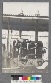 The engine and exhaust pipes of Best Machine showing air clarifier and spark arresters