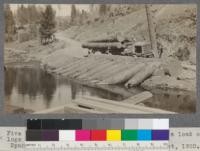 Five ton Fageol truck and trailer delivering a load of 32' logs at log pond. Spanish Peak Lumber Company, Quincy, California. August, 1920. E.F