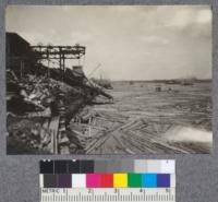 Pulp logs and log elevator of St. Maurice Lumber Company, subsidiary of International Paper Company at Three Rivers, Quebec. The timber has come down the St. Maurice River from the property of the company which is being managed on a sustained yield basis. The logs are taken up the elevator as indicated in Picture #10