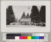 Flag raising at Whitaker's Forest headquarters during the Tulare-Fresno 4-H camp, July 1942. Metcalf