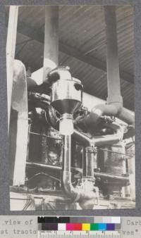 A close up view of "oven", Clarifier and Carburetor attachment on C.L. Best tractor. The flat top of "oven" is a danger point