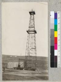 A steel oil well derrick. The walking beam is of wood. The only other wooden parts are the platforms. This derrick costs, erected, 50% or more more than the wooden derrick. Some companies have standardized on steel derricks to the exclusion of wood. The steel derrick has but one genuine advantage - a higher salvage value - if it must be taken down over a dry well. It is claimed to be superior because it is fire-proof. However, since fires at oil wells are usually gas fires, the steel derrick is hopelessly wrecked. Bakersfield, California. December, 1927