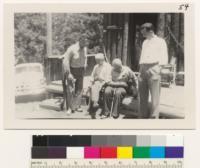 Assistant Manager Hixson, Manager William Hall, Metcalf and graduate student Tonkin of University of California Hospital on porch at Redwood Cabin