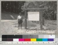 Sign at the picnic ground entrance to Howard Forest near Willits, Mendocino County, with Superintendent John Philbric of the Northwestern CCC Camp. Sign and silhouette made in Berkeley at cost of about $25.00. Mounting done by CCC crew under Philbric's direction. May 1940. Metcalf