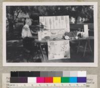 Professor Woodbridge Metcalf and exhibits used in forestry demonstration at 33rd annual 4-H Club Convention, Davis campus, University of California. "How Forest Trees Grow." September 1953