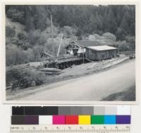 Sawmill of Berry & Son at Cazadero, California (Merril H. Berry). Six-foot band head rig; gang edgers; all electric drive; boom is used for raising logs from small pond to log deck, and for loading lumber to trucks. Cuts redwood and Douglas fir. 4-6-44. E. F