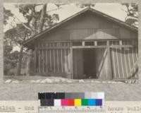 End view of Asilomar tent house building, showing long central hall which is boarded up with doors into each of the canvas-partitioned rooms