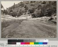 Tehachapi Flood Area. September 1932. View of Tehachapi Creek channel where measurement of cross section indicated a peak flow of 50,000 second feet. Metcalf and Renner making the measurements. This water did 5 million dollar damage along Tehachapi Creek