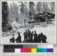 Redwood Region. Senator G.M. Biggar's forestry committee viewing a small sawmill in Jackson Valley, upper South Fork, Eel River, near Branscomb. Note slab fire and pile dangerously close to inflammable brush and timber. R. & G. Lumber Company. Aug. 2, 1946. E. F