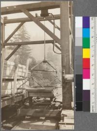 Method of unloading sorting table trucks onto R.R. cars for distribution to yards at Willits. Hydraulic lift. Note transfer turntable car under sorting table truck. Northwestern Lumber Company near Willits. April, 1920. E. F