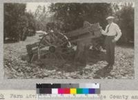 Farm Advisor Wahlberg of Orange County and root pruner used for cutting roots of Eucalyptus windbreaks between breaks and first orchard row. It will cut to 52" depth, is used about every two years and gives good results