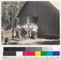 Camp Califorest. Mess call at dinner. The doors have just been opened, the dog gets excited. August 1, 1939. E.F