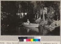 Camp Califorest. The camp's new rowboat, built by Joe Wohletz and Professor Fritz, afloat on the camp pool. The boat was christened the night before at a dance. The name, Califorest '31. Werner poses at the oards, Iverson in the bow. Dam and camp tents in the background. E.F. July 1931