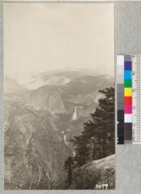 View of Nevada Falls and Vernal Falls from Glacier Point with Little Yosemite Valley in the background and the crowns of Jeffrey Pines in the foreground. Metcalf, 1925