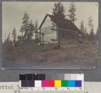 Spotted Bear Ranger Station. Flathead National Forest. Four logs protrude for porch not completed