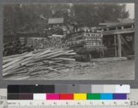 Nakusp Lumber Company, Nakusp, Arrow Lakes, B.C. Car of #1 Larch and Douglas Fir sawn ties (pile of #2 ties on tie deck behind)