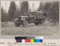 Reo truck on Plumas National Forest - new 1928. The central compartment carries the horse. It is closed by the ramp which lets down at the rear. The horse needs to be trained to back down this straight. Racks on the side contain hand tools and the reversible scraper for making fire lines. Metcalf. November, 1928