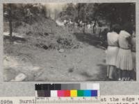 Burning a long brush pile at the edge of the forest during the demonstration at Paradise, Butte County