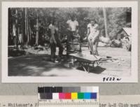 While leaders to the number of 50 discussed plans and procedure for summer camps, Tulare County 4-H Seniors worked on the construction of two drinking fountains with help from Caretaker Clyde Williams. Whitaker's Forest, June 6, 1950. Metcalf