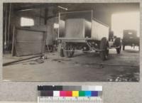 Three ton Mack truck with booster brakes in machine shop for placing of body iron and fenders. Note double hose compartment. October, 1930