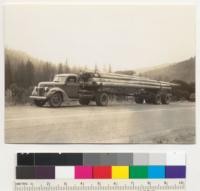 Piling. Douglas fir "second growth." From stock ranch land on Salmon Creek west of Miranda, Humboldt County, California. 20 piles, 50' long. Ford truck operated by Oakson, en route to Alameda about 260 miles from stump to creosoting yard. 7-14-41 E. F