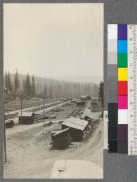 Yards from end of the timber deck at mill. Showing empty pile of foundations. Yard no longer used for storage. Showing tramway house in distance. Spanish Peak Lumber Company, Quincy, California. August, 1920. E.F