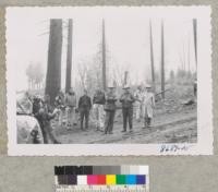 Society of American Foresters in the rain listen to discussion of blister rust men Harris and Howard. A high quality sugar pine site is worth protecting. June 1953. Metcalf