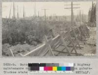 Burned forests cause increased highway maintenance cost. Snow fence in burn on Auburn-Truckee state highway. July 1933. Metcalf