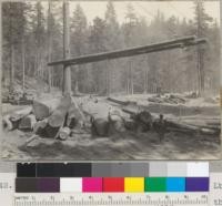 Peeling redwood at the landing. Casper Lumber Company, Camp 20. General view of landing. Logs are peeled to the right; loading to the left. 8/20/40. E.F