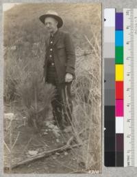 Mr. William R. Tanner, Assistant Supervisor of Forestry, Los Angeles City Schools, and one of his prize Coulter pines planted by students in the upper Tujunga Canyon burn spring of 1926. Metcalf. Nov. 1927