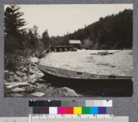 Splash dam on east branch of Penobscot River, Maine. River driving bateau in foreground