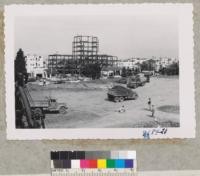 Construction begins in the hole of the NW corner of campus for Public Health Department. State Public Health Building framework in background. June 1953. Metcalf